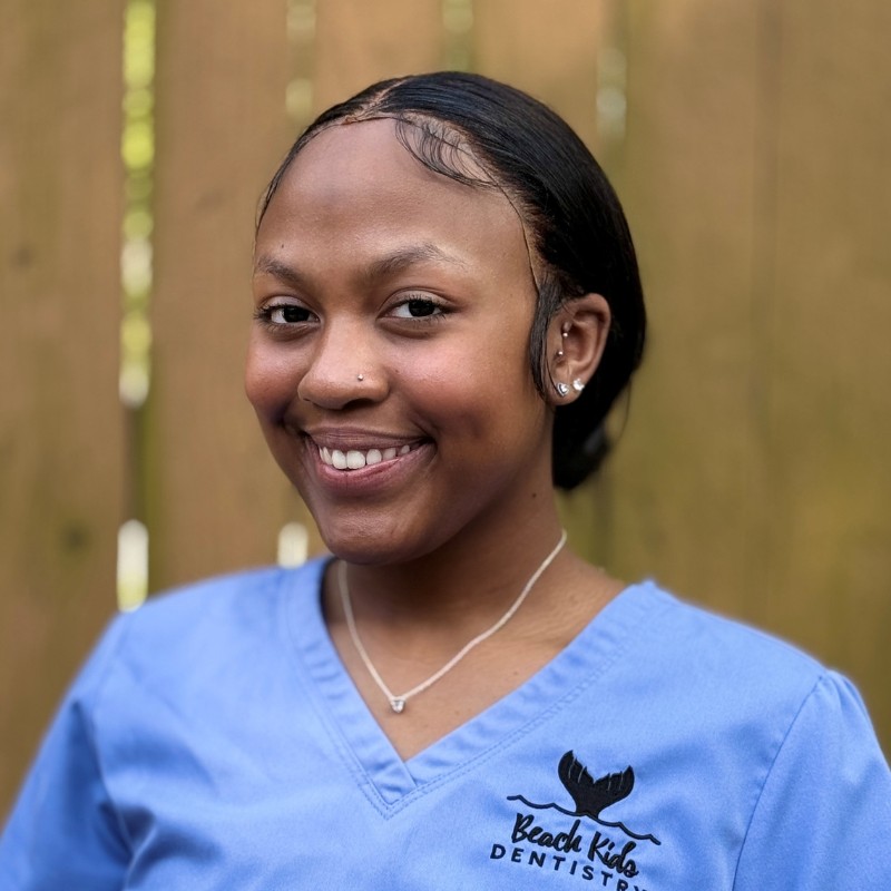 Beach-kids-dentistry-milan-dental-assistant Dental assistant smiling in beach kids dentistry uniform providing pediatric dental care